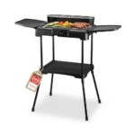 TZS First Austria - Elektro Standgrill 2200W - 2-in-1 Tischgrill mit Windschutz - Stufenloser Hitzeregler - Rauchfreies Grillen mit 2 Seitentischen - Balkon & Tischgrill - Schwarz